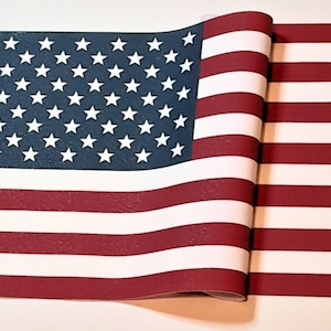 May include: A folded American flag with red and white stripes and a blue field of stars. The flag is made of a textured material.