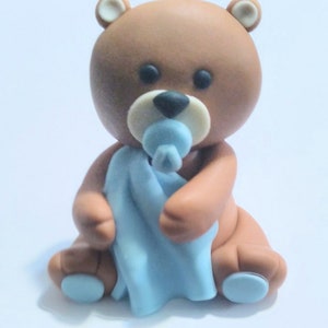 Fondant teddy bear with blanket cake topper
