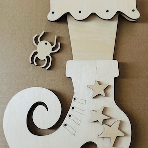 May include: Wooden Halloween-themed cutouts. Includes a witch's boot with star accents, a spider, and a hat. The pieces are made of unfinished wood, ready for painting or decorating. Perfect for DIY crafts.
