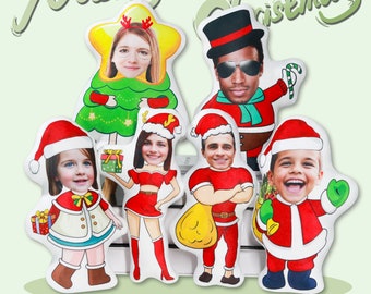 May include: A set of six Christmas-themed pillows featuring different characters. Each pillow has a different person's face on it. The characters include a Christmas tree, Santa Claus, a snowman, and a reindeer. The pillows are all white with red and green accents.
