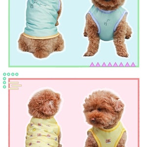 May include: Two brown dogs wearing sleeveless shirts. The first dog is wearing a light blue shirt with a small graphic on the front. The second dog is wearing a yellow shirt with a pattern of small animal faces.