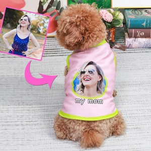 May include: A pink dog vest with a green trim features a photo of a woman wearing sunglasses and the text "my mom".