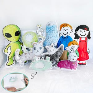 May include: A selection of colourful, hand-drawn plush toys, featuring an alien, robot, owl, and cartoon characters. The toys have a childlike design, ideal for a nursery or playroom, with a charming, playful aesthetic.