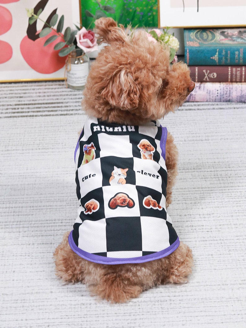 May include: A brown and white dog vest with a checkered pattern and images of dogs. The vest has a purple trim and the text "niuniu", "cute", and "clever" printed on it.