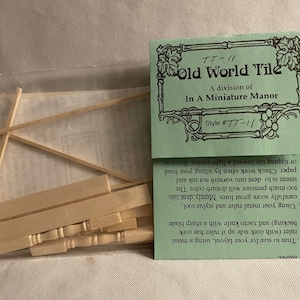 May include: A package of wooden tile pieces for miniature dollhouse building. The package includes instructions for scoring grout lines and trimming the tiles to size. The package is labeled "Old World Tile" and "In A Miniature Manor".