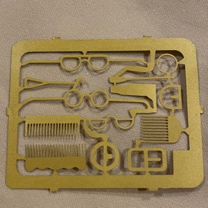 1/12 or 1” scale,  Brass sheet has 4 glasses, 3 buckle, 3 combs