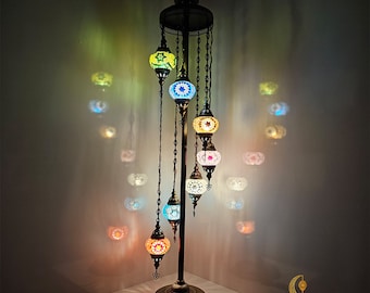 May include: A floor lamp with a gold metal base and six colorful mosaic glass globes. The lamp is 40 inches wide and 67 inches tall.  MULTICOLOR 2