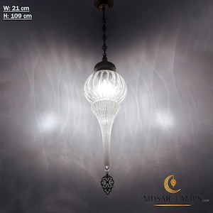 May include: A clear glass pendant light with a decorative metal finial. The light is hanging from a chain and has a bulb inside. The light is 21 inches wide and 109 inches high.