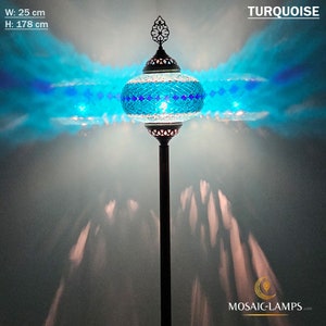 May include: A turquoise mosaic glass floor lamp with a decorative metal base. The lamp is 25 inches wide and 70 inches tall. The lamp is lit and casting a blue glow on the wall.