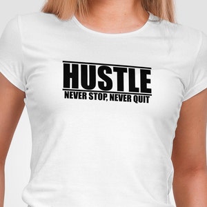 May include: White t-shirt with black text that reads "Hustle Never Stop, Never Quit"