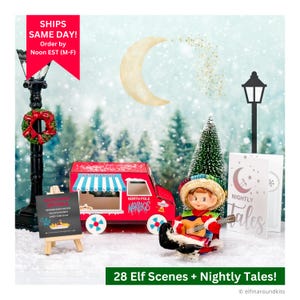 May include: A festive Christmas scene featuring a red food truck with "North Pole Nachos" text, an elf playing a guitar, and miniature street lamps. The scene includes a sign with menu items and the text "28 Elf Scenes + Nightly Tales!"