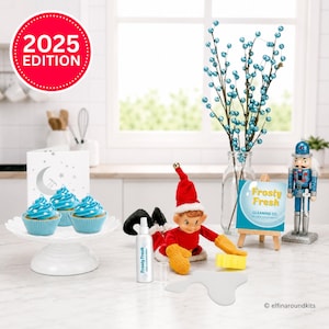 May include: A 2025 Edition kit featuring three cupcakes with blue frosting and star sprinkles on a white stand, a doll in a red outfit with yellow mittens, a Frosty Fresh spray bottle, a cleaning sign, and a blue nutcracker figurine.