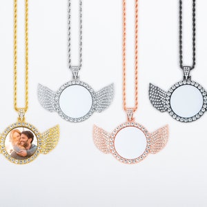 May include: Four silver, gold, rose gold, and black chains with a photo pendant in the shape of wings. Each pendant has a clear, round space for a photo.