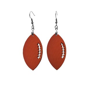 May include: A pair of orange football-shaped earrings with silver hooks.
