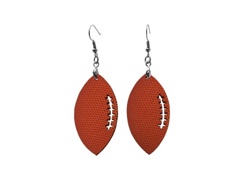 May include: A pair of orange football-shaped earrings with silver hooks.