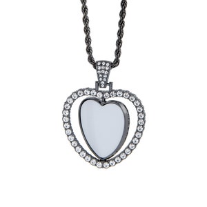 May include: A black heart-shaped pendant necklace with a clear crystal centre and a rope chain. The pendant is surrounded by smaller clear crystals.