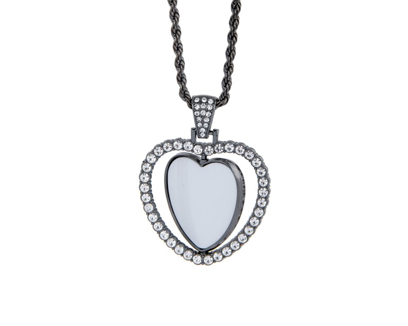 May include: A black heart-shaped pendant necklace with a clear crystal centre and a rope chain. The pendant is surrounded by smaller clear crystals.