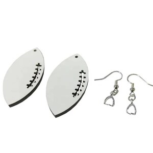 May include: A pair of white football-shaped earrings with black stitching detail. The earrings are attached to silver-toned ear wires.