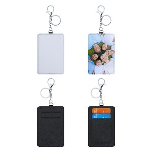 May include: Four keychains with different designs. Two are black with a silver chain and two are white with a silver chain. One black keychain has two card slots. One white keychain has a photo of a family.