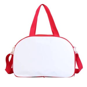 May include: A white canvas duffel bag with red trim and red straps. The bag has a zipper closure.