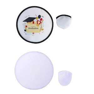 May include: Two white and black graduation-themed foldable reflectors. One reflector has a black border and a graphic with a graduation cap, text that says "Happy Graduation", and other celebratory elements. The other reflector is plain white.