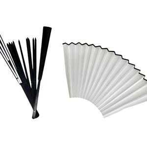 May include: Two folding fans, one black and one white. The black fan is closed and has a black handle. The white fan is open and has a black border.