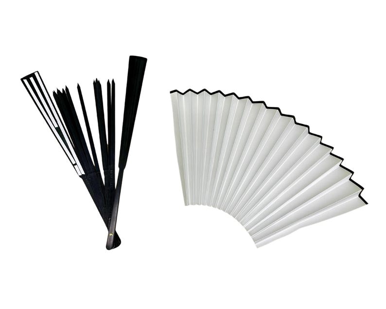 May include: Two folding fans, one black and one white. The black fan is closed and has a black handle. The white fan is open and has a black border.