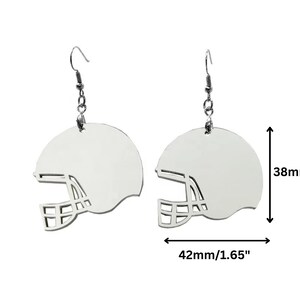 May include: A pair of silver earrings shaped like football helmets. Each earring measures 1.65 inches wide and 1.5 inches tall.