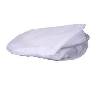 May include: A white, folded laundry bag with a circular metal frame. The bag is made of a lightweight, semi-transparent fabric. The bag is designed to be collapsible for easy storage.