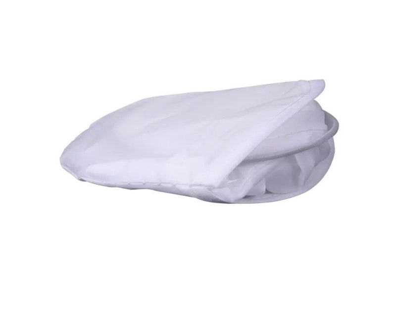 May include: A white, folded laundry bag with a circular metal frame. The bag is made of a lightweight, semi-transparent fabric. The bag is designed to be collapsible for easy storage.