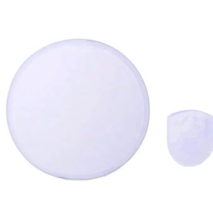 May include: A white, round object and a smaller, white, rounded object. The objects are set against a white background. The round object is a disc shape. The smaller object is a rounded, cup-like shape.