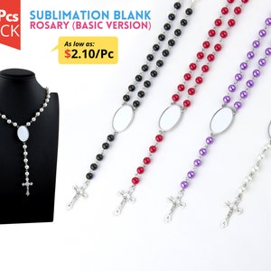 May include: A display of rosaries with various colored beads, including black, red, purple, and white. Each rosary features a silver crucifix and an oval-shaped blank insert for customization. The image also shows a rosary displayed on a black mannequin.