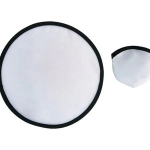 May include: A white and black photography reflector, circular when open and folded into a smaller, triangular shape. The reflector has a black border and is designed to bounce light.
