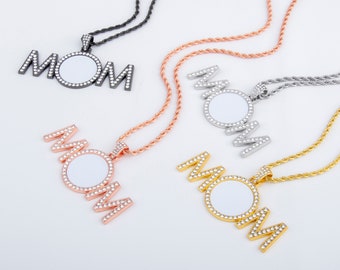May include: Four necklaces featuring the word "MOM" spelled out in silver, gold, rose gold, and black metal. Each necklace has a round, blank photo charm with a clear background and a border of small, clear rhinestones.