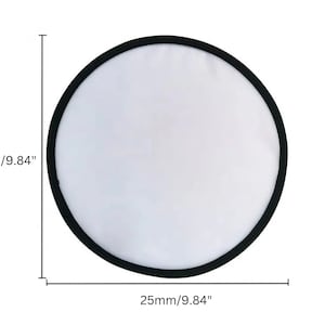 May include: A circular white reflector with a black border, measuring 9.84 inches (25mm) in diameter. The reflector is designed to bounce light and is commonly used in photography and videography.