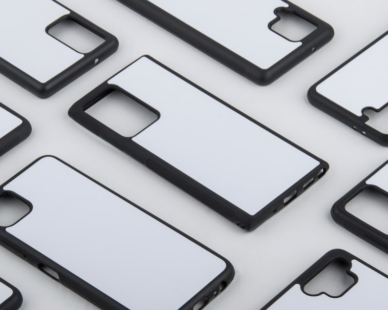 May include: Multiple black phone cases with white blank inserts. The cases are designed to protect a smartphone.