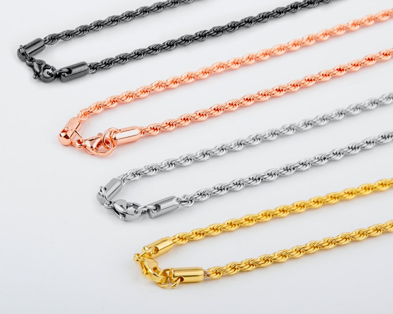 May include: Four different rope chains, each with a lobster clasp closure. The chains are black, rose gold, silver, and gold.