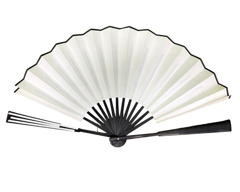 May include: A white folding fan with a black handle and black trim. The fan is closed and the handle is extended.