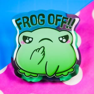 May include: A green frog with a grumpy expression and the text "FROG OFF!" on a colourful background.