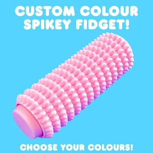 May include: A pink spiky fidget toy with a cylindrical shape, set against a bright blue background. The text "CUSTOM COLOUR SPIKEY FIDGET!" and "CHOOSE YOUR COLOURS!" are displayed in white. This sensory toy is designed for tactile stimulation.