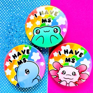 May include: Three colorful button pins with a rainbow background and a cartoon animal on each. The text on each pin reads "I Have MS".