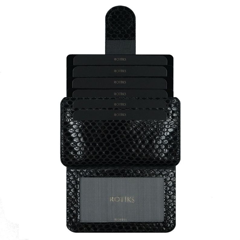 May include: Black leather card holder with a textured snake skin pattern. The card holder has six slots for cards and a clear window for an ID card. The brand name "ROTHYS" is printed on the front of the card holder.
