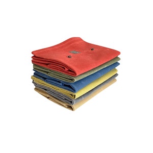 May include: A stack of six folded fabric squares in various colors, including red, green, blue, yellow, and gray. The fabric squares are made of a soft, textured material.