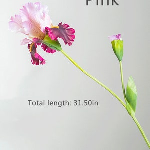 May include: A single pink and purple artificial iris flower with a green stem and leaves. The flower is 31.50 inches long.