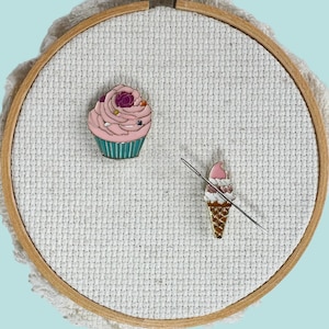 Set of 2 ice cream cone and pink cupcake enamel needle minder with strong magnet, perfect for holding needles while cross stitching, embroidery, quilting, needlepoint or sewing. Fun drink-themed needle holder for stitchers.