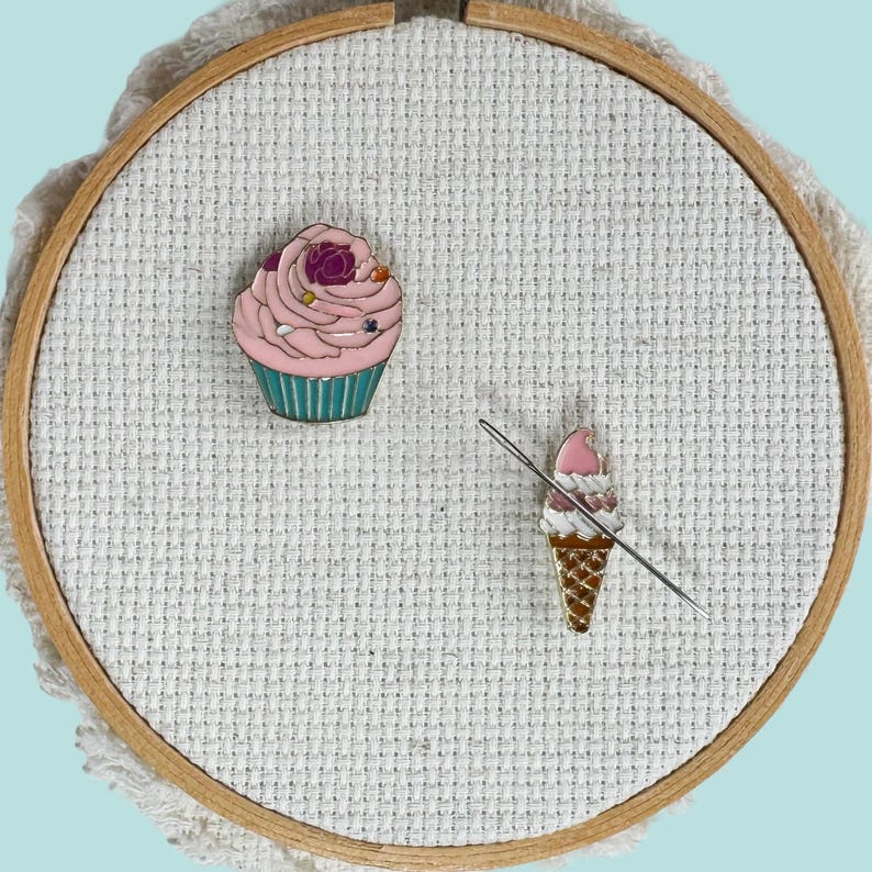 Set of 2 ice cream cone and pink cupcake enamel needle minder with strong magnet, perfect for holding needles while cross stitching, embroidery, quilting, needlepoint or sewing. Fun drink-themed needle holder for stitchers.