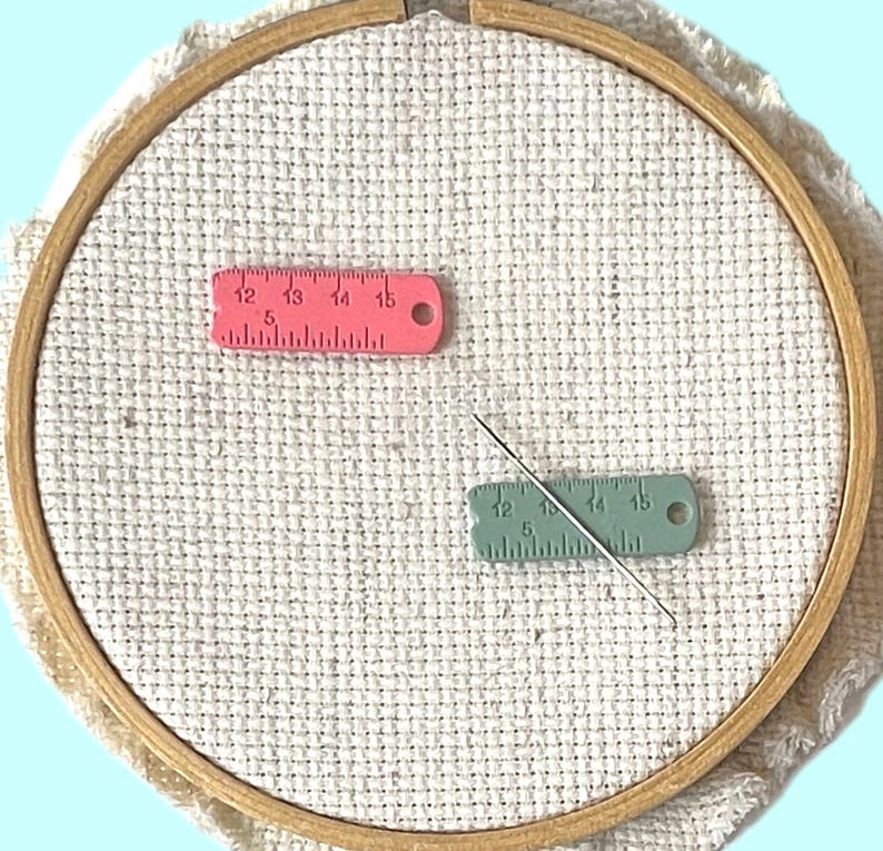 Set of 2 pink and green enamel measuring tape needle minder for cross stitch, embroidery, quilting, needlepoint, crewel, tapestry, and sewing, magnetic stitching accessory, cute pink craft tool for knitters and crocheters, durable enamel needle minder gift.