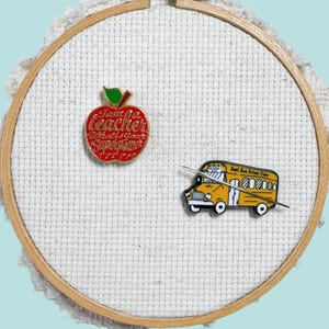 Set of 2 red teacher apple and yellow school bus magnetic enamel needle minder. Cute enamel accessory for cross stitch, embroidery, knitting, crocheting, sewing and needlepoint.