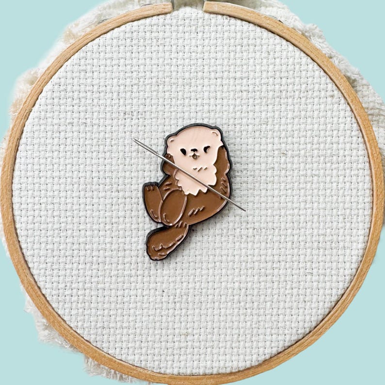Brown otter magnetic needle minder – woodland animal enamel accessory for cross stitch, embroidery, and needlepoint – cute stitching gift for nature and wildlife lovers.