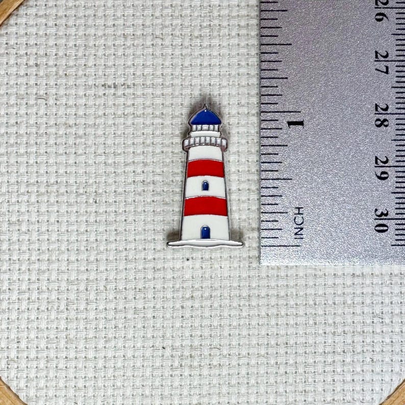 Lighthouse magnetic enamel needle minder – coastal-themed needle holder for cross stitch, embroidery, sewing, quilting, or needlepoint. Great gift for nautical or beach lovers.